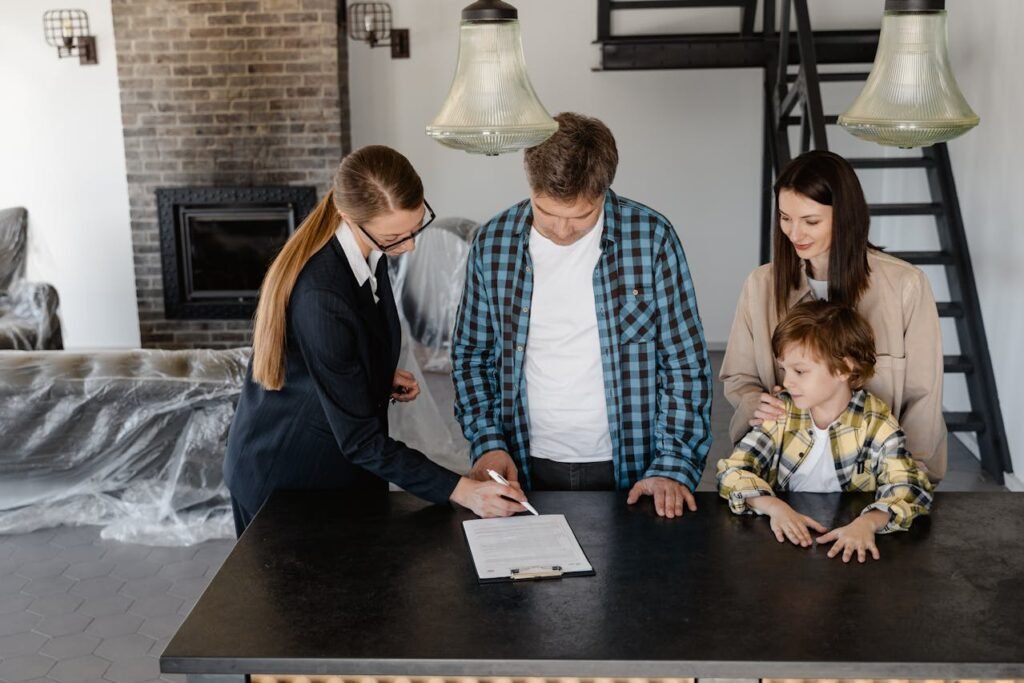 Family discussing home inspection report with real estate agent in modern interior, emphasizing pre-purchase evaluation and informed decision-making.